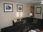 Large sectional, ceiling fan, area map, and local artist drawings round out the living room.